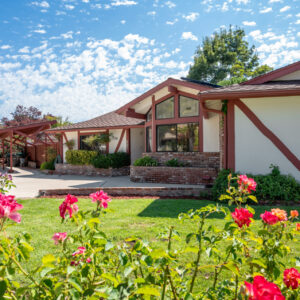 exterior view of 116 1st street solvang ca Pink roses frame the danish style home.
